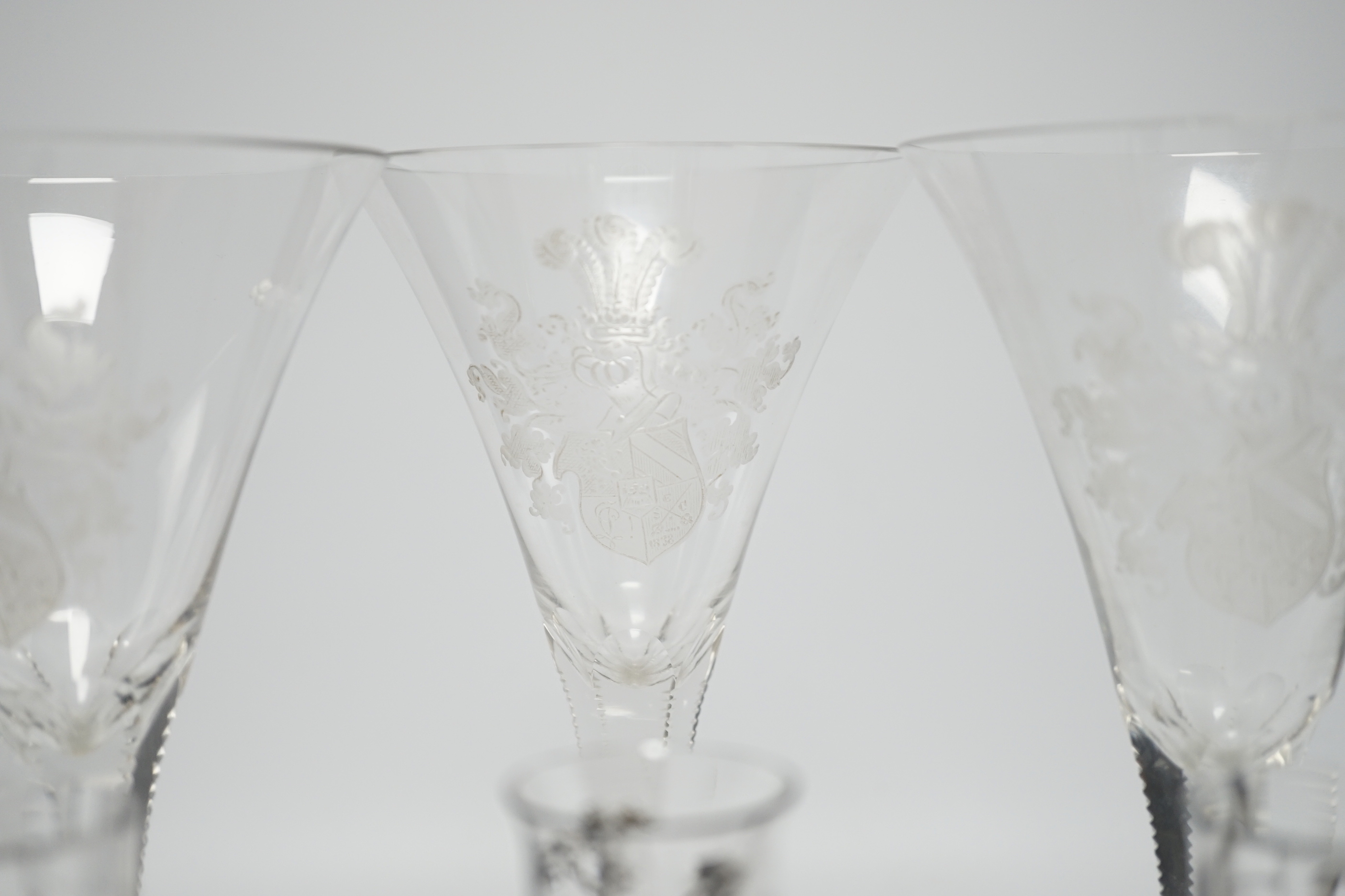 Set of three armorial crest etched flutes and three enamelled liqueur glasses, largest, 23cm high